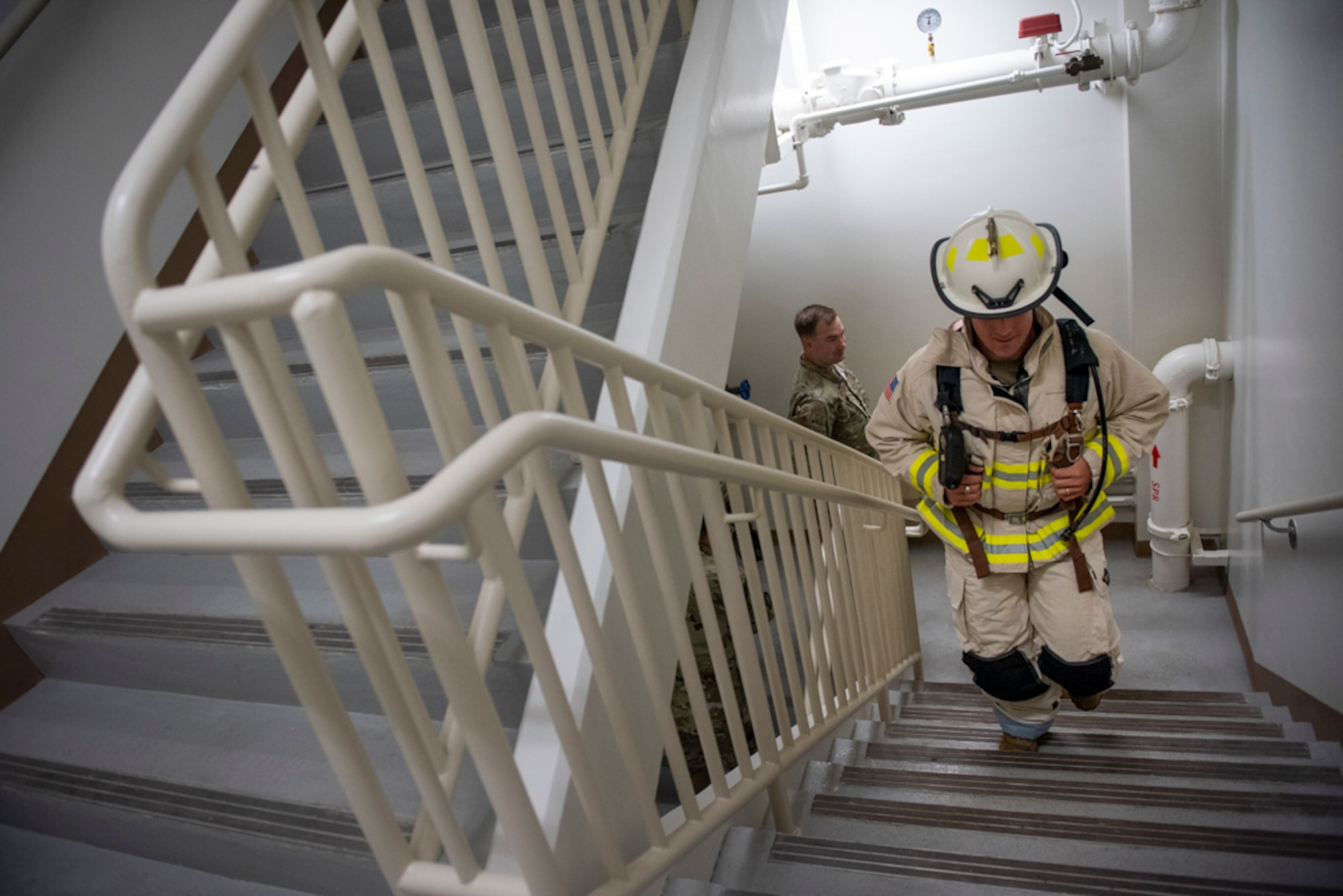 Col. Joshua Wood, 51st Fighter Wing commander, climbs 110 flights of stairs wearing fire fighter equipment during a 20th Anniversary 9/11 Remembrance Ceremony at Osan Air Base, Republic of Korea, Sept. 11, 2021.