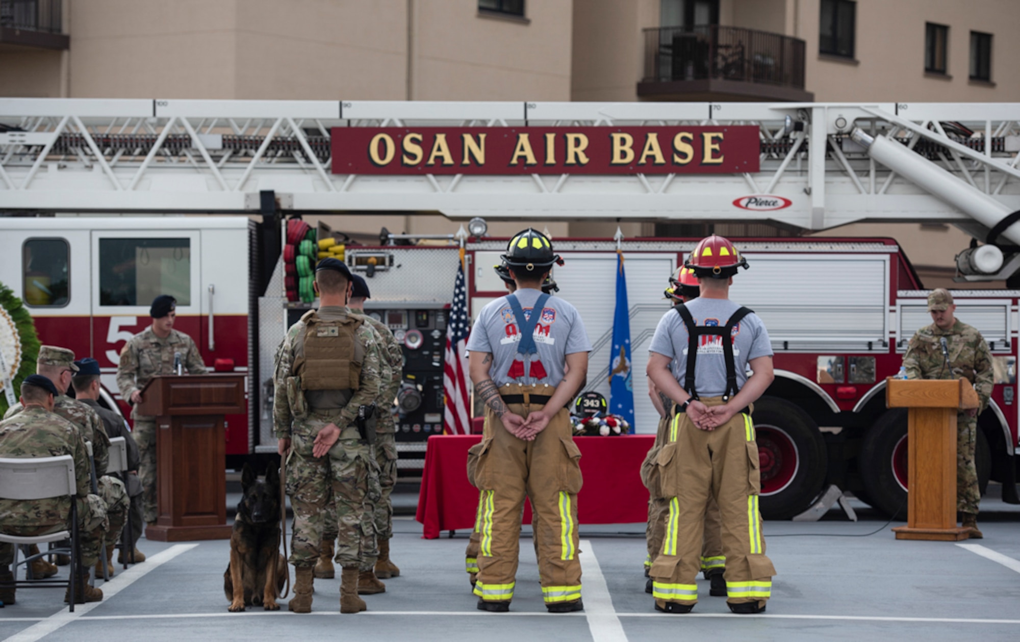 Fire fighters assigned to the 51st Civil Engineer Squadron and 51st Security Forces Squadron stand in formation to represent the volunteers that perished during a 20th Anniversary 9/11 Remembrance Ceremony at Osan Air Base, Republic of Korea, Sept. 11, 2021.