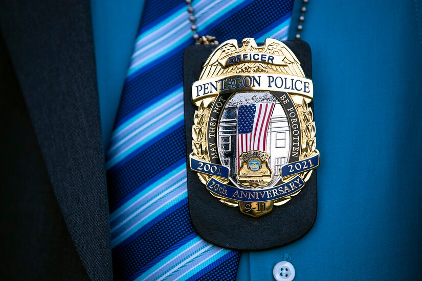 A close up of a police badge that honors the 20th anniversary of the 9/11 attacks.
