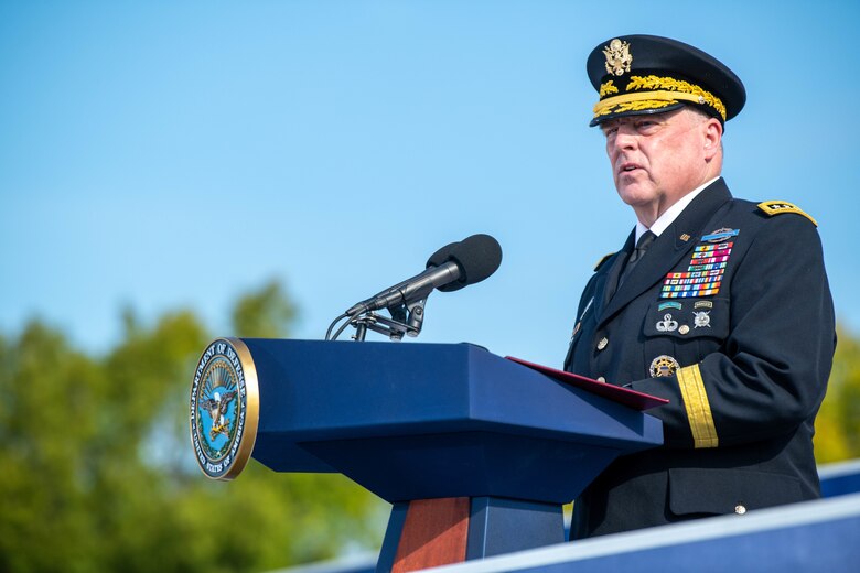 An Army general in uniform speaks at a podium.