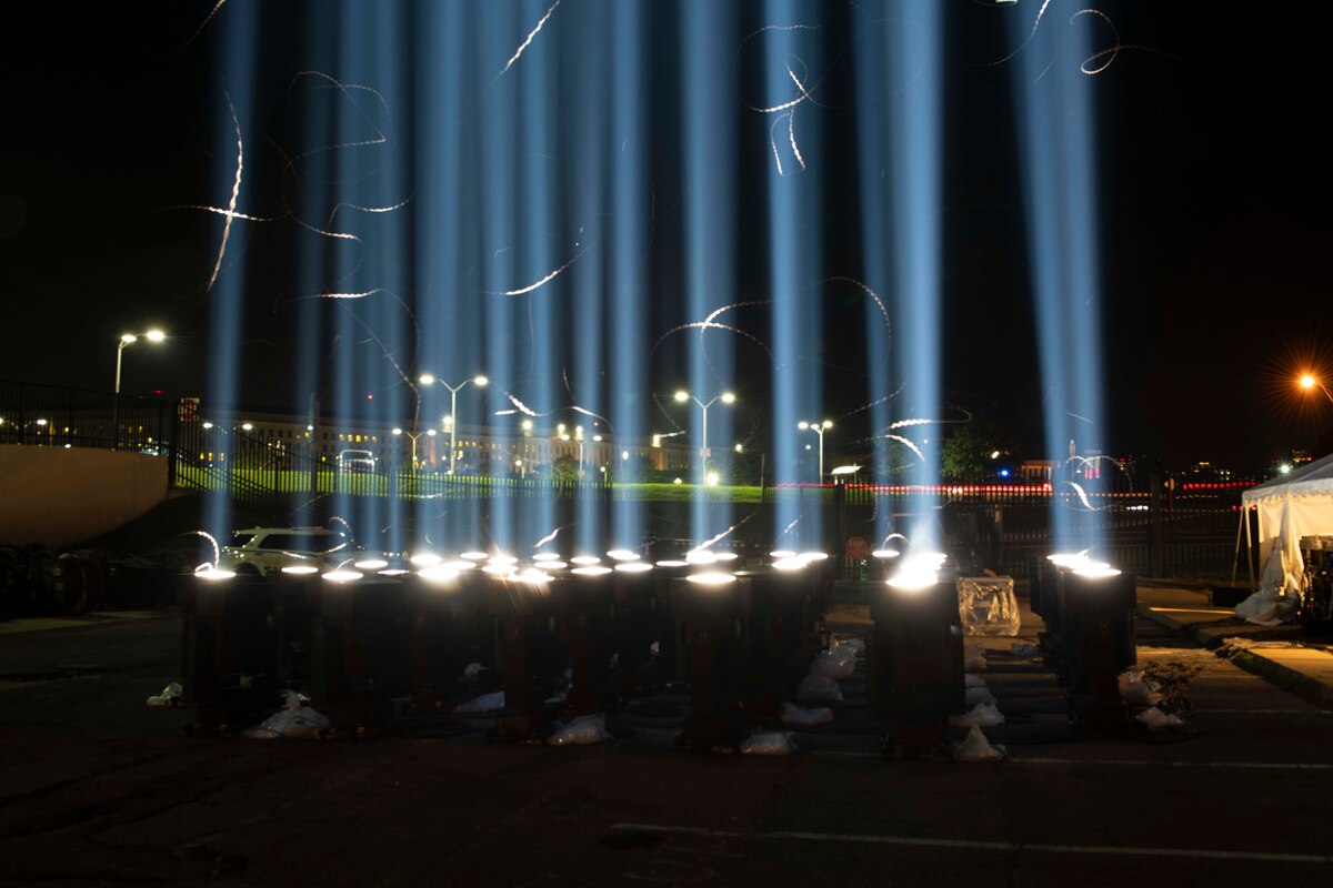 A stream of multiple blue lights shoot skyward.