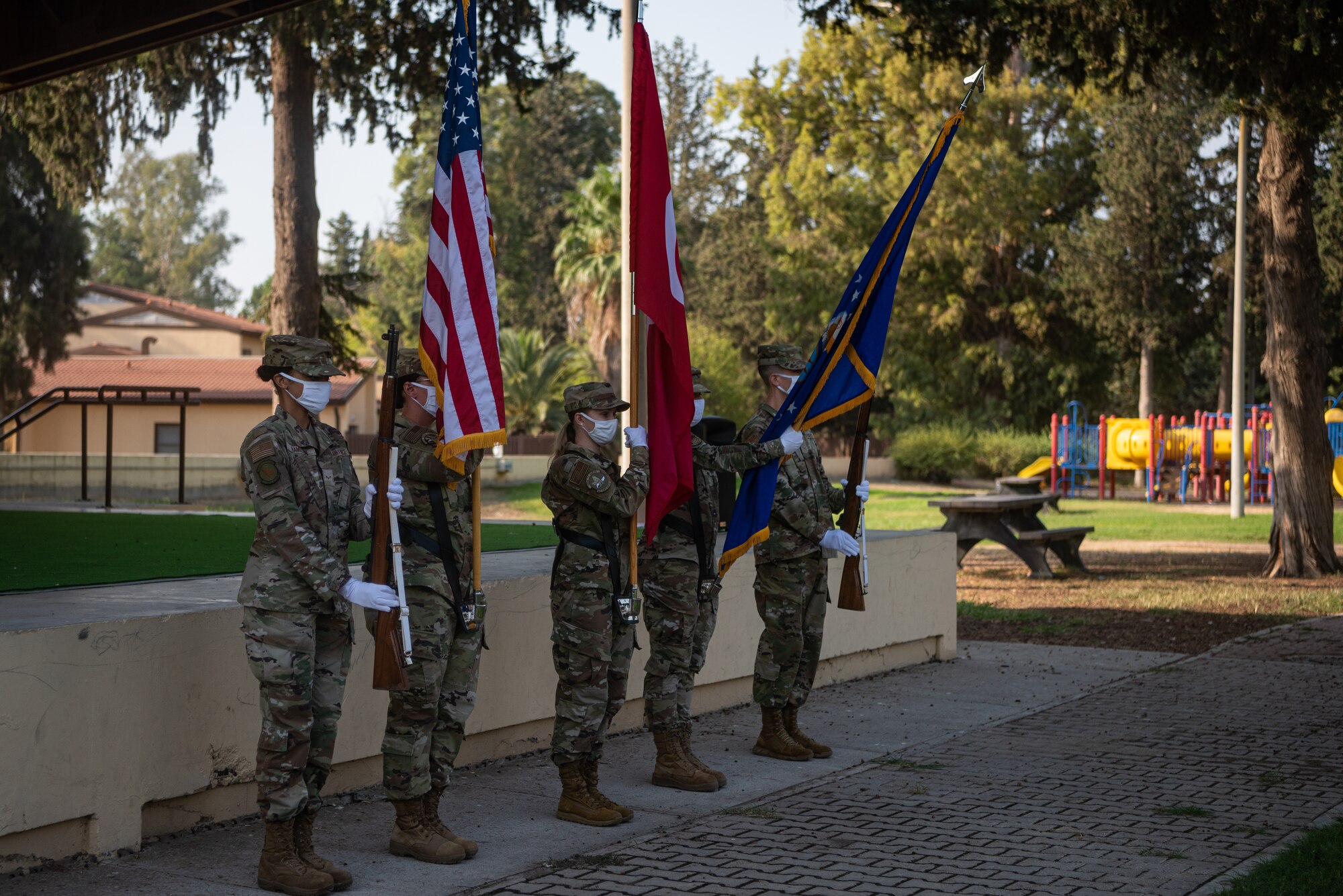 Honor guardsmen presenting flags at ceremony