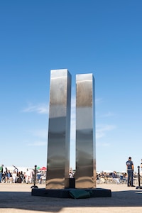 A replica of the twin towers is unveiled at a memorial ceremony at Pease Air National Guard Base, New Hampshire, Sept. 11, 2021. The replica was designed and built entirely by Airmen assigned to the 157th Air Refueling Wing. (U.S. Air National Guard photo by Staff Sgt. Taylor Queen)