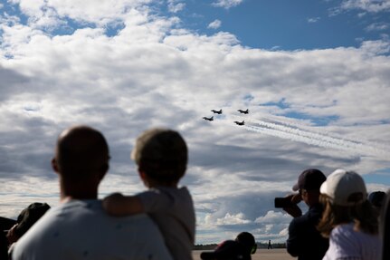 Military family members and friends attending the Thunder Over New Hampshire Airshow Open House watch as the  United States Air Force Air Demonstration Squadron "Thunderbirds” perform aerial maneuvers,  Pease Air National Guard Base, Portsmouth, New Hampshire, Sept. 10, 2021. Sept. 10 was military family day, where military family members and friends could see the air show performances before opening to the wider public. (U.S. Army National Guard photo by Devin Bard)