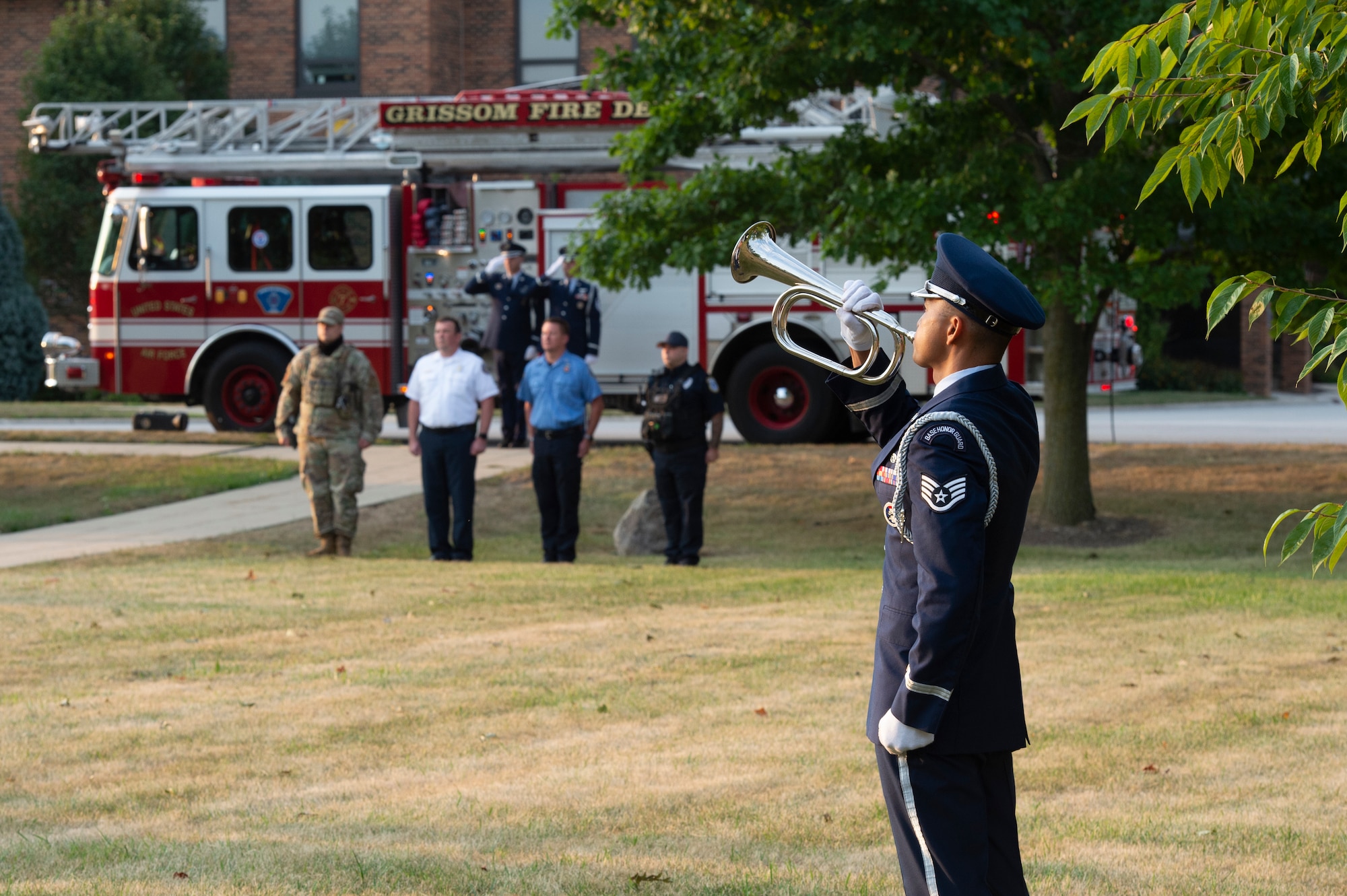 Staff Sgt. Jeffrey Merza, 434th Civil Engineering Squadron engineering assistant apprentice, plays a bugle during a 9/11 remembrance ceremony at Grissom Air Reserve Base, Indiana, Sept. 11, 2021.  Merza played taps to honor those who lost their lives during the attack 20 years ago. (U.S. Air Force photo by Staff Sgt. Michael Hunsaker)