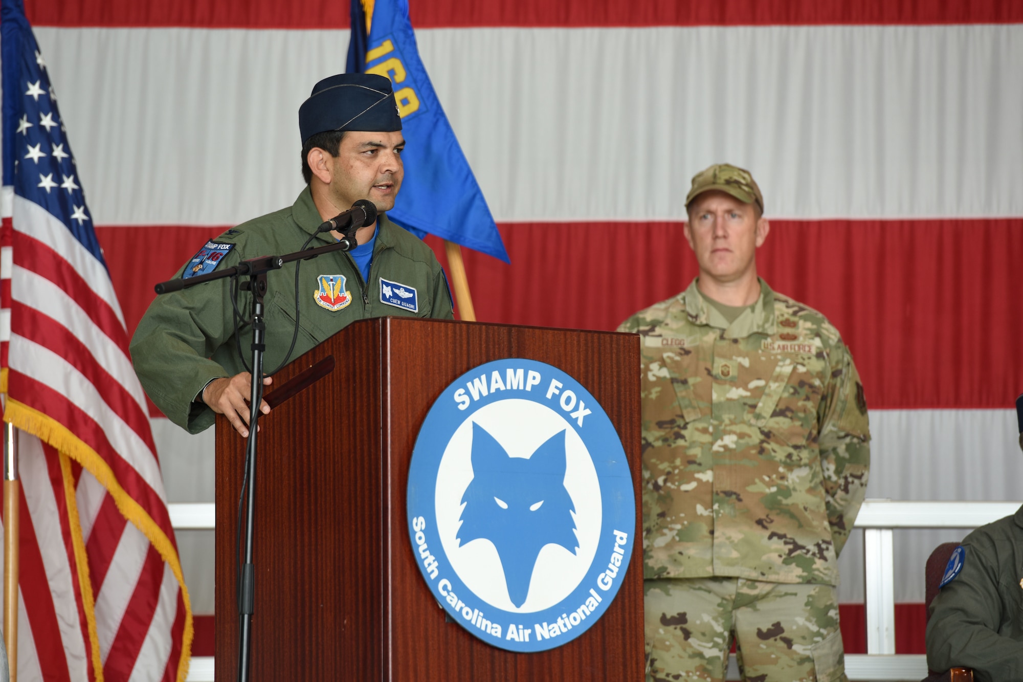 U.S. Air Force Col. Quaid Quadri Jr., the incoming wing commander of the 169th Fighter Wing, speaks at the South Carolina Air National Guard’s 169th Fighter Wing change of command ceremony at McEntire Joint National Guard Base, South Carolina, Sept. 11, 2021, where U.S. Air Force Quadri. assumes command from Col. Akshai Gandhi. Brig. Gen. Boris Armstrong, Chief of Staff, South Carolina Air National Guard, presides over the ceremony. (U.S. Air National Guard photo by Tech Sgt. Megan Floyd, 169th Fighter Wing Public Affairs)