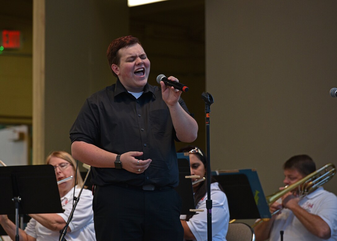 Kaden Wright, Angelo State University student, sings during the 9/11 Remembrance Ceremony at the Bill Aylor Sr. Memorial RiverStage in San Angelo, Texas on Sept. 11, 2021. Wright sang a cover song with the San Angelo Community Band to honor the fallen on the 20th anniversary of 9/11. (U.S. Air Force photo by Senior Airman Ashley Thrash)
