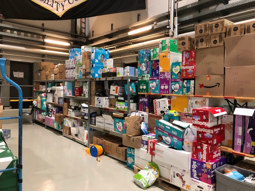 Stacks of diapers and other supplies for Afghan families gathered at a military base.