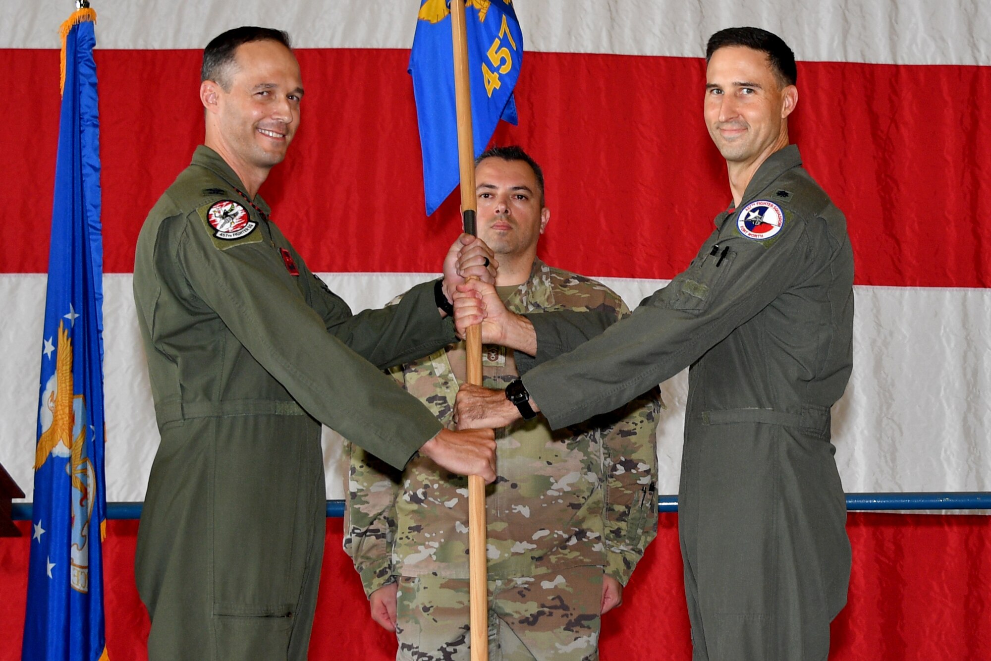 (left) Col. Benjamin “Marsa” Harrison, 301st Fighter Wing Operations Group commander, passes the guideon to Lt. Col. David “Shave” Snodgrass, 457th Fighter Squadron commander, September 12, 2021, at U.S. Naval Air Station Joint Reserve Base Fort Worth, Texas. The change of command ceremony is a time-honored military tradition that signifies the transfer of authority from the outgoing commander to the new commander. (U.S. Air Force photo by Staff Sgt. Randall Moose)