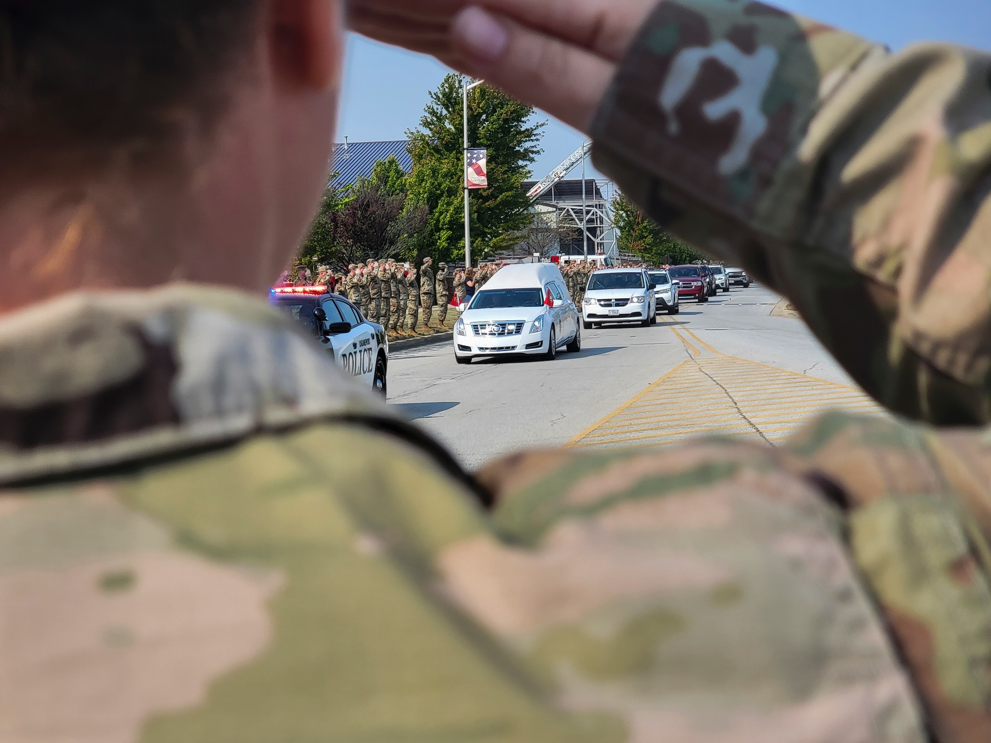 Members of the Hoosier Wing line the road and render a salute as the procession transporting the remains of U.S. Marine Corps Cpl. Humberto A. Sanchez of Logansport, Indiana, passes by Sept. 12, 2021 at Grissom Air Reserve Base, Indiana. Sanchez was one of 13 U.S. service members killed Aug. 26, 2021, as the result of an enemy attack while supporting evacuation efforts for Operation Freedom’s Sentinel in Kabul, Afghanistan. (U.S. Air Force photo by Staff Sgt. Chris Massey)