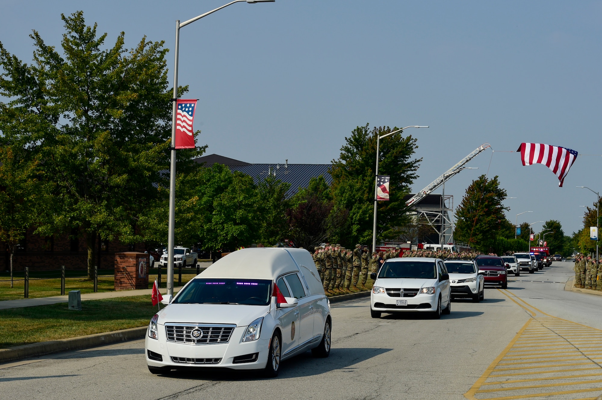 Members of the Hoosier Wing line the road and render a salute as the hearse transporting the remains of U.S. Marine Corps Cpl. Humberto A. Sanchez of Logansport, Indiana, passes by Sept. 12, 2021 at Grissom Air Reserve Base, Indiana. Sanchez was one of 13 U.S. service members killed Aug. 26, 2021, as the result of an enemy attack while supporting evacuation efforts for Operation Freedom’s Sentinel in Kabul, Afghanistan. (U.S. Air Force photo by Staff Sgt. Jeremy Blocker)