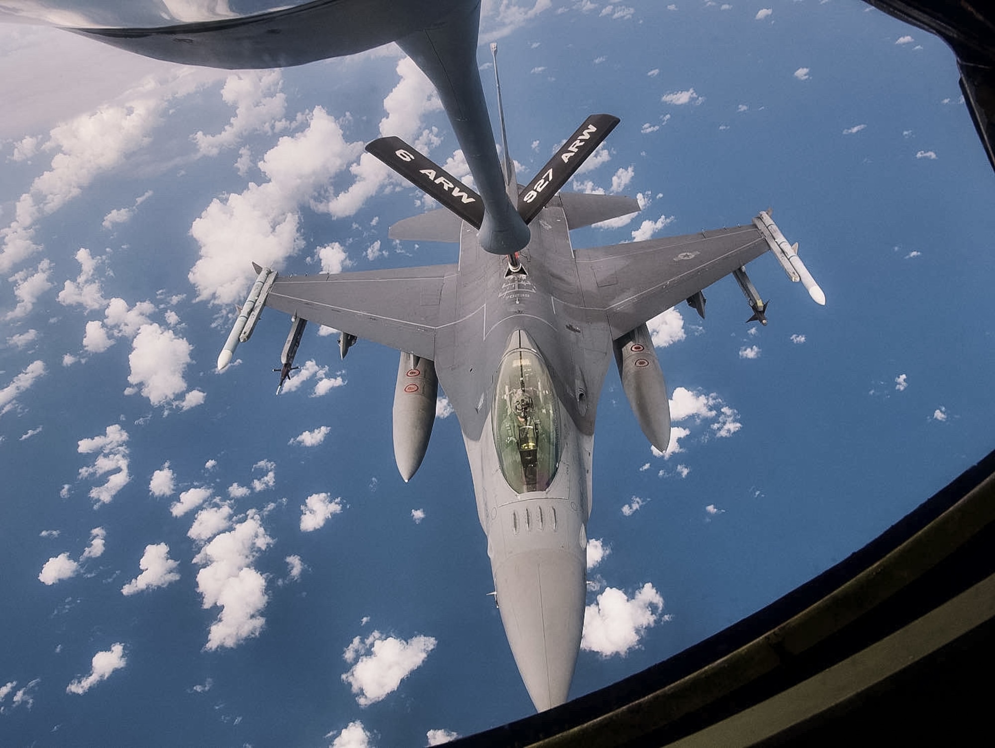 A KC-135 Stratotanker with the 927th Air Refueling Wing, Florida, refuels an F-16 Fighting Falcon with the 482nd Fighter Wing, Florida, on September 11, 2021.  On the Stratotanker were 927th ARW quarterly and annual award winners who earned the opportunity to watch a refueling, the Wing’s primary mission.  (U.S. Air Force photo by Staff Sgt. Tiffany A. Emery)