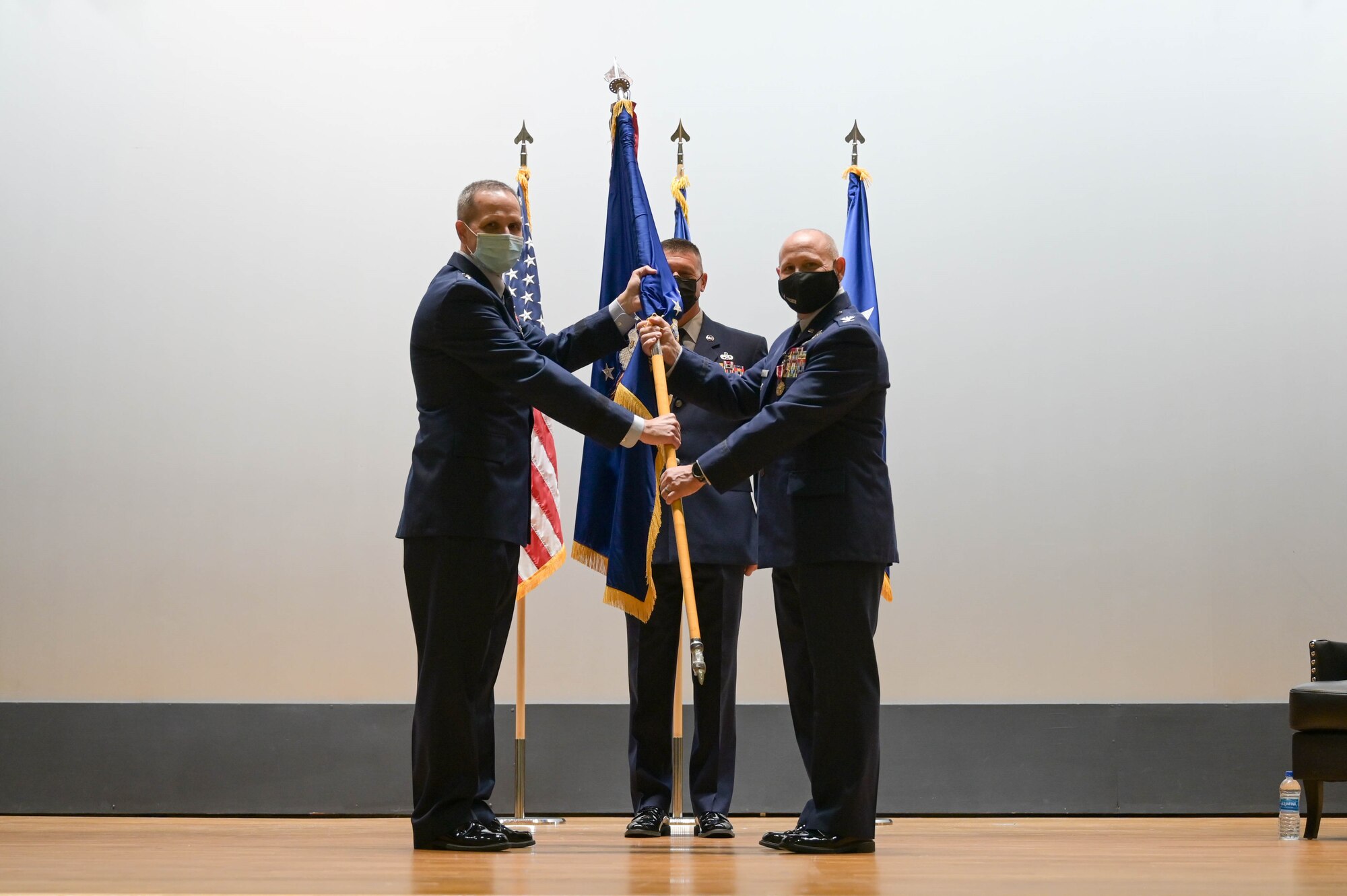 Maj. General Jeffrey T. Pennington, 4th Air Force commander, passes the guidon to Col. Kurt A. Matthews as he takes command of the 927th Air Refueling Wing during a ceremony Sept. 11, 2021 in the base theater at MacDill Air Force Base, Florida. Matthews previously served as the vice commander of the 22nd Air Force at Dobbins Air Reserve Base, Georgia. (U.S. Air Force photo by Staff Sgt. Alexis Suarez)