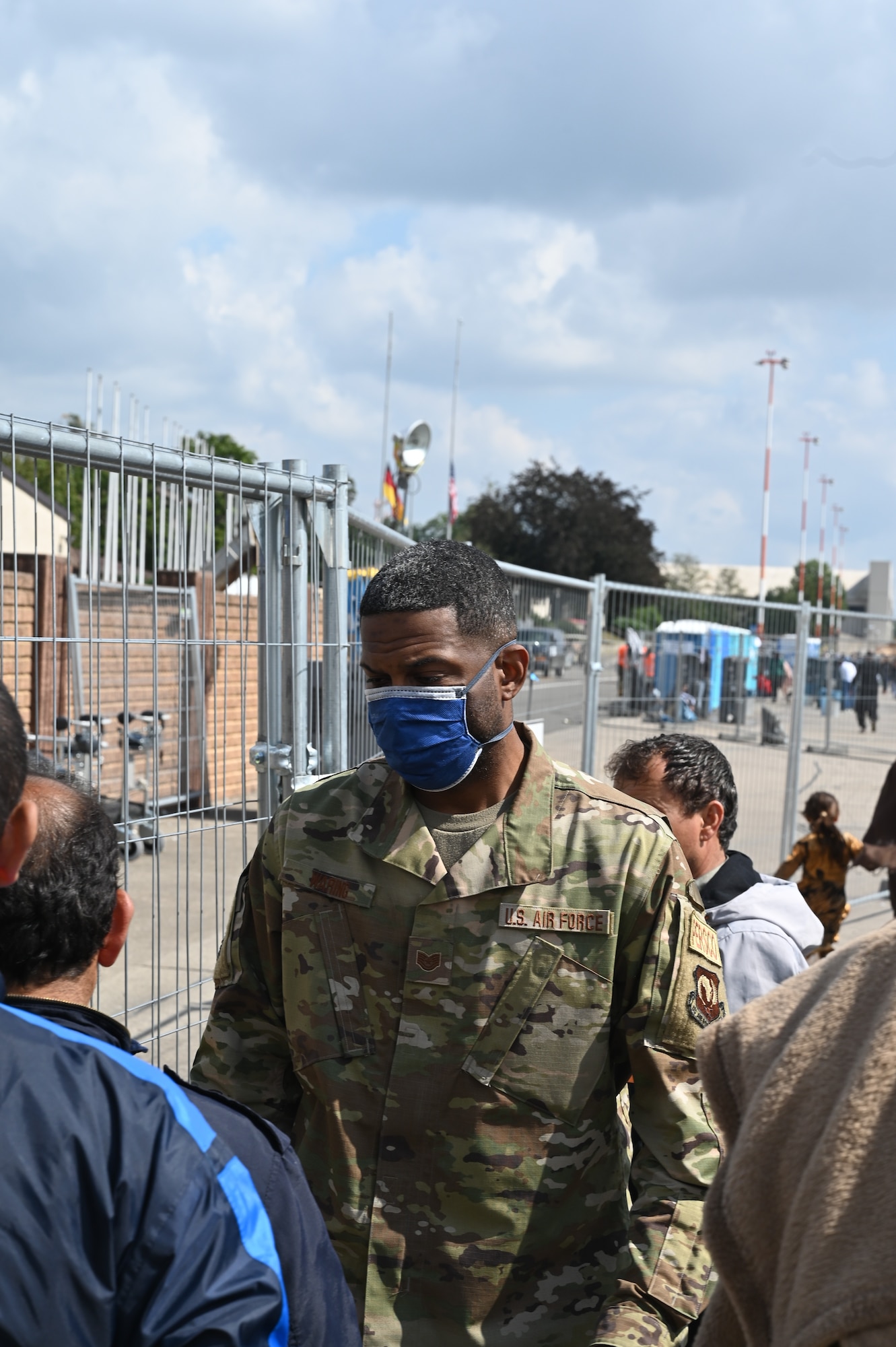 U.S. Air Force Tech. Sgt. Kenton Waring, 435th Air Expeditionary Wing personnel support for contingency operations non-commissioned officer in charge, speaks to evacuees during Operation Allies Refuge at Ramstein Air Base, Germany, Sep. 3, 2021. Over 30,000 evacuees have received support such as temporary lodging, food, medical screening and treatment and more at Ramstein Air Base while preparing for onward movements to their final destinations. (U.S. Air Force photo by Senior Airman Caleb S. Kimmell)