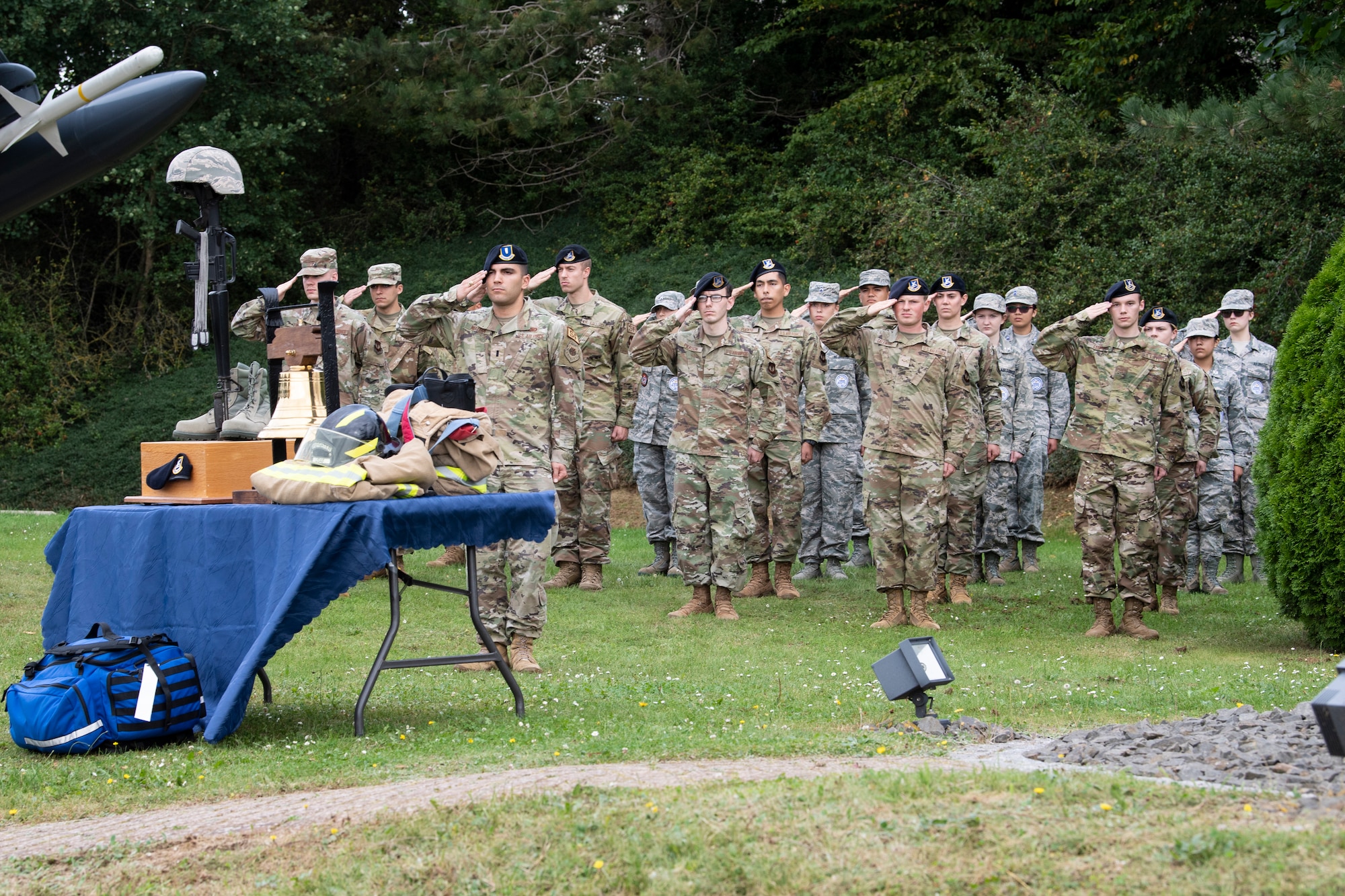 First responders from the 52nd Fighter Wing salute in a formation during a 9/11 Remembrance Ceremony Sept. 10, 2021, on Spangdahlem Air Base, Germany. This formation was a tribute to the men and women first responders who lost their lives as a result of the 9/11 tragedy. (U.S. Air Force photos by Staff Sgt. Melody W. Howley)