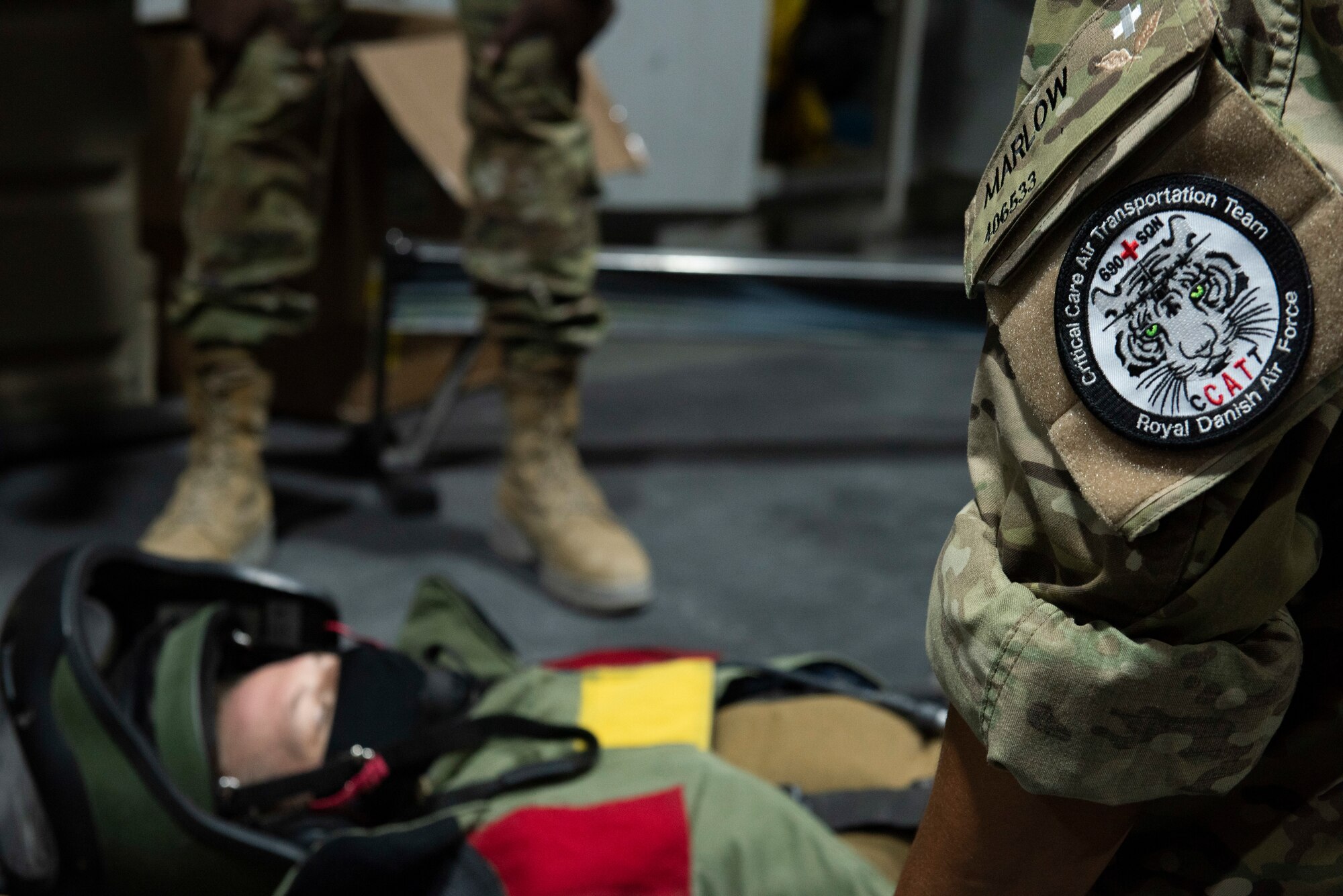 A Royal Danish Air Force medic examines a bomb suit