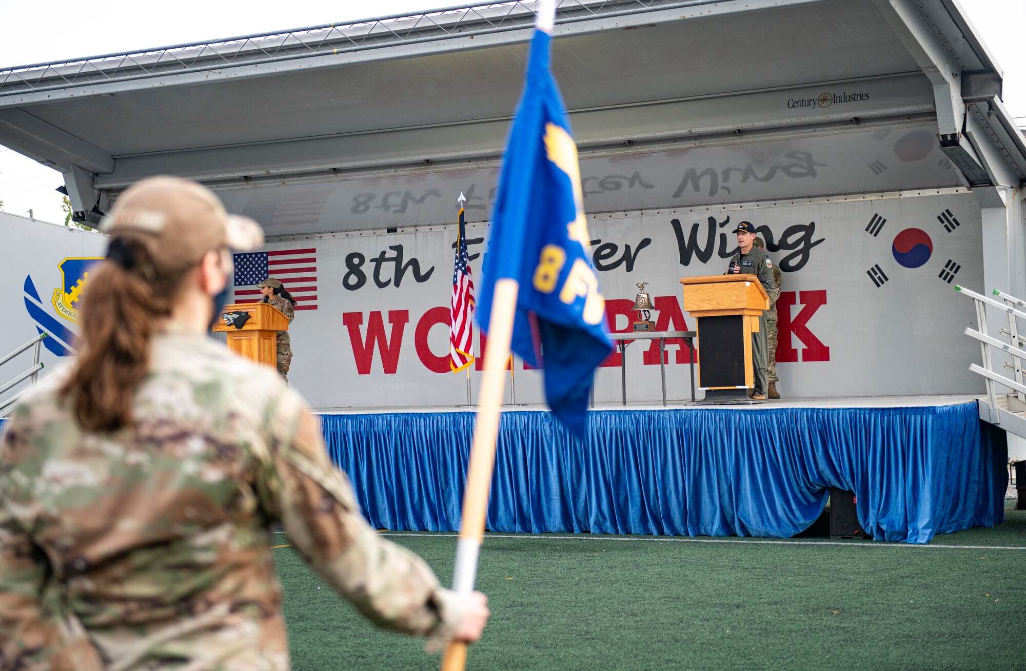 A commander gives remarks during a ceremony.