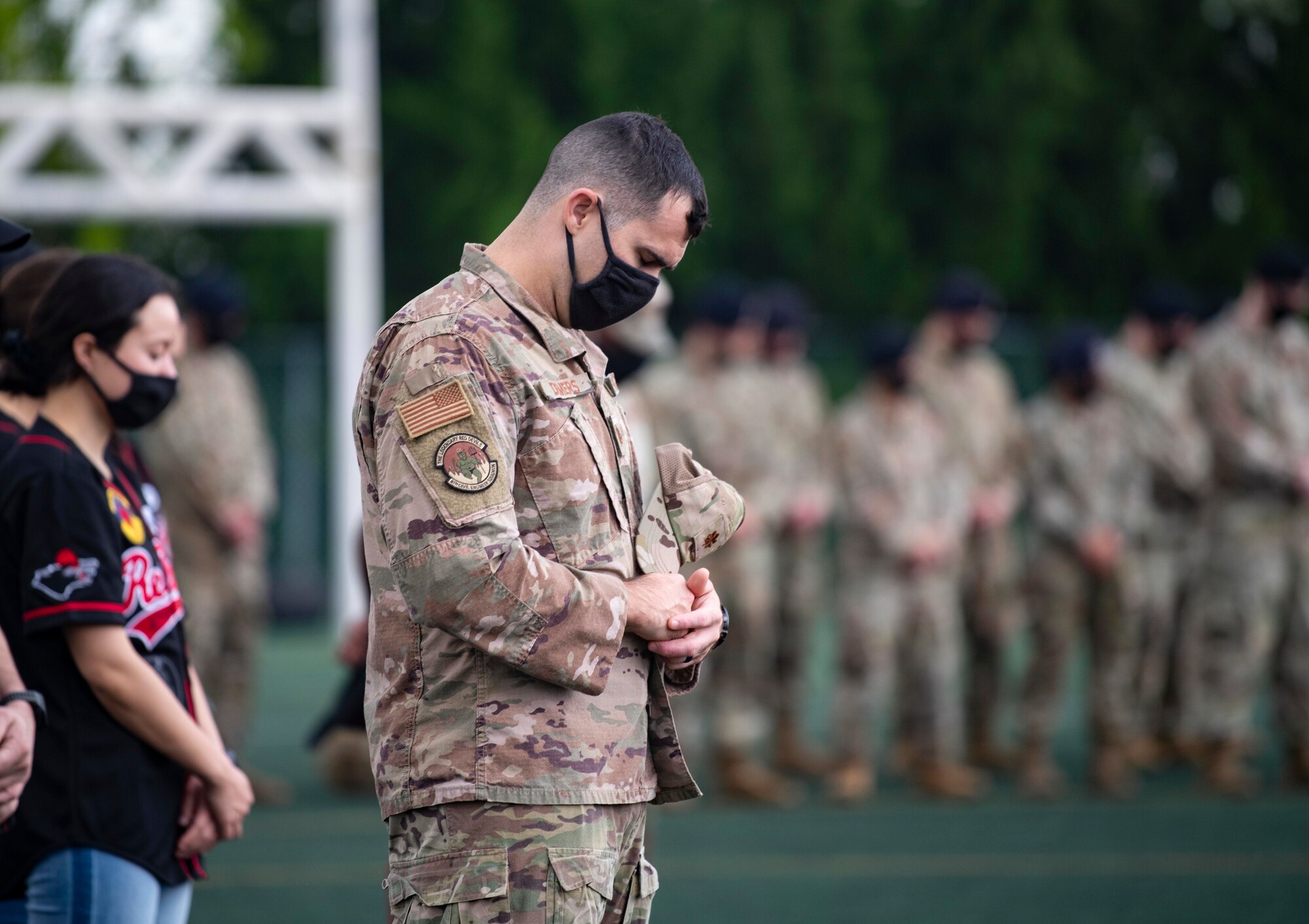 An Airman bows his head during a prayer.