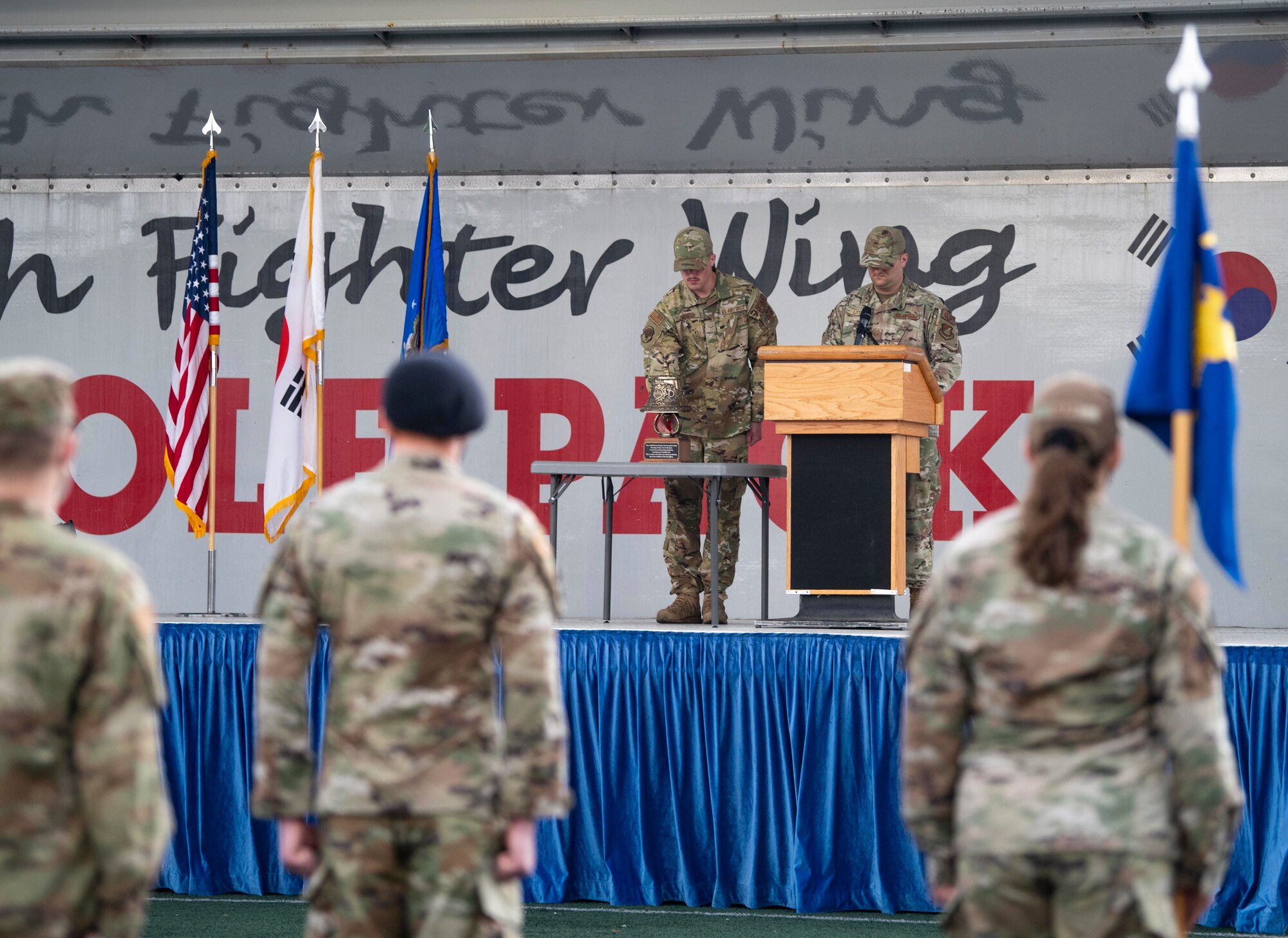 An Airman rings a bell.