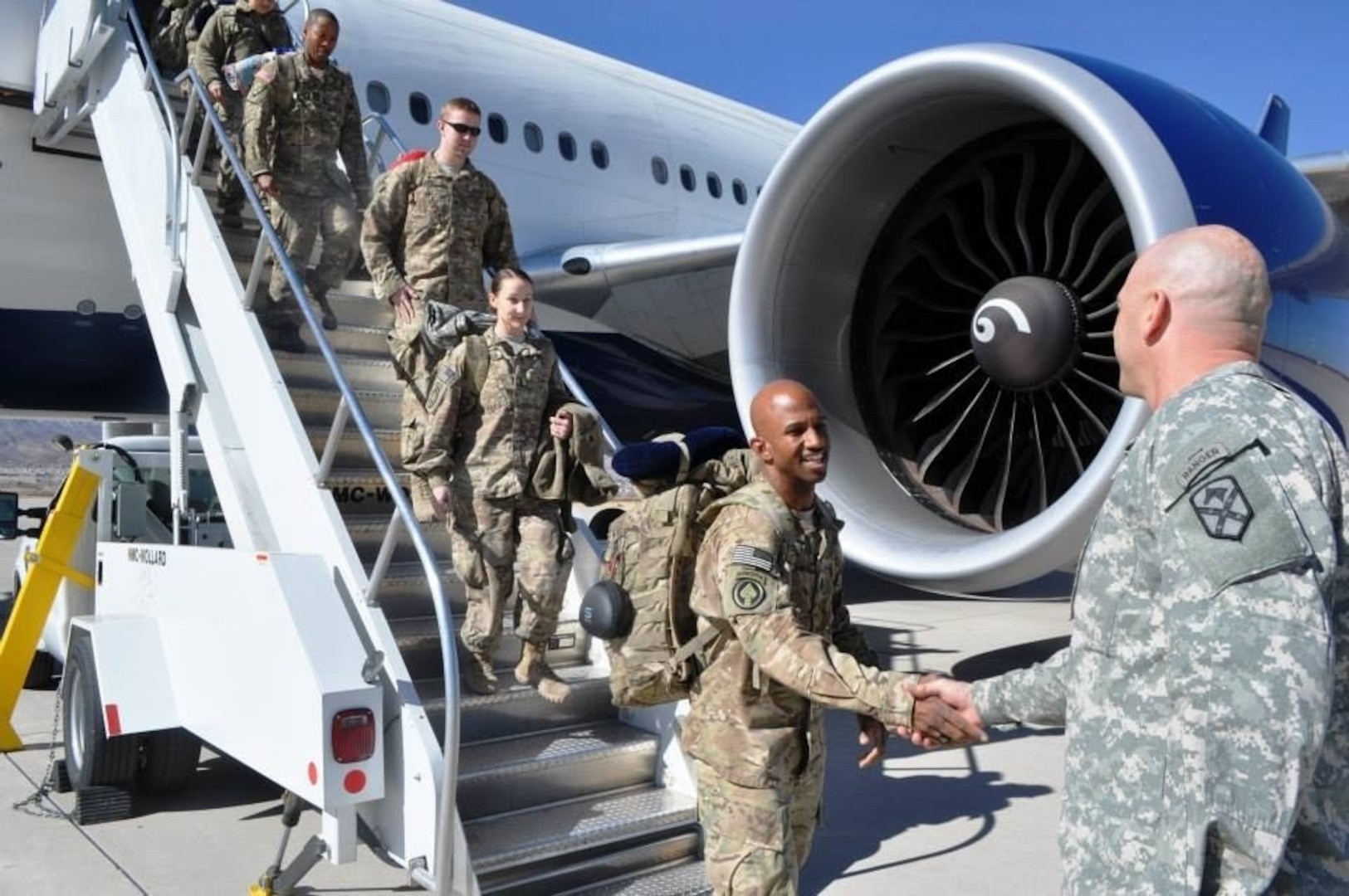 U.S. Army Command Sgt. Maj. Aarion Franklin, Maryland National Guard, is greeted after returning from deployment to Afghanistan Jan. 28, 2014, at Fort Bliss, El Paso, Texas. Franklin was among the many MDNG members who responded to the attacks on Sep. 11, 2001.