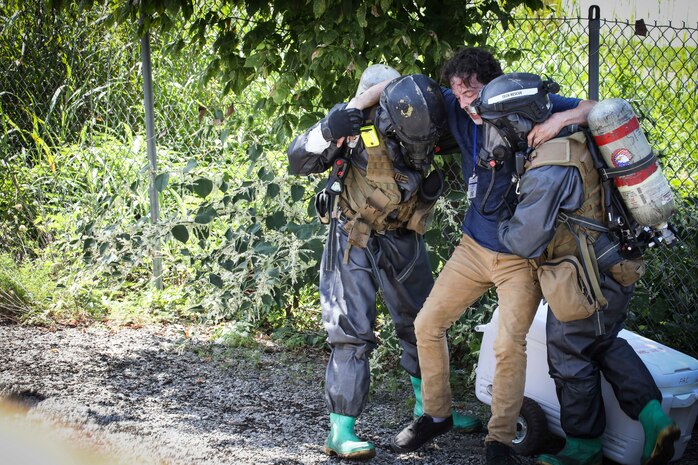 Belle, West Virginia (August 28, 2021) – U.S. Marines from The Chemical Biological Incident Response Force practice decontamination measures during a notional response to an emergency involving train colliding with a bus in Belle, West Virginia. Vigilant Guard is an annual large-scale disaster response exercise sponsored by the U.S. Northern Command in conjunction with the National Guard Bureau that brings federal, state, and local military personnel, public safety, first responders, and private sector partners together. The multi-day, hands-on and stimulated training exercise supports the development, enhancement, and interoperability of disaster response assets within a joint environment. (U.S. Marine Corps Photo by Staff Sgt. Kristian S. Karsten/Not Released)
