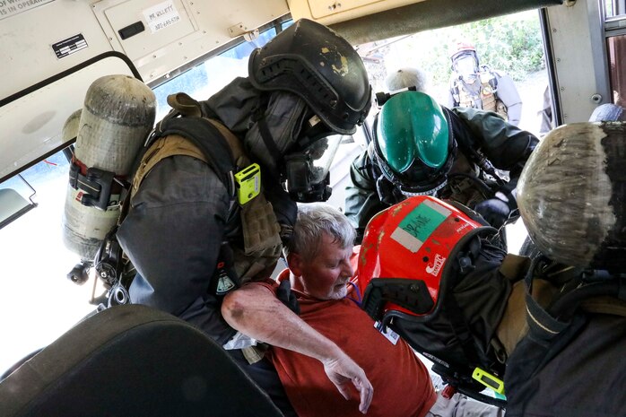 Belle, West Virginia (August 28, 2021) – U.S. Marines from The Chemical Biological Incident Response Force practice decontamination measures during a notional response to an emergency involving train colliding with a bus in Belle, West Virginia. Vigilant Guard is an annual large-scale disaster response exercise sponsored by the U.S. Northern Command in conjunction with the National Guard Bureau that brings federal, state, and local military personnel, public safety, first responders, and private sector partners together. The multi-day, hands-on and stimulated training exercise supports the development, enhancement, and interoperability of disaster response assets within a joint environment. (U.S. Marine Corps Photo by Staff Sgt. Kristian S. Karsten/Not Released)