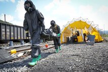 Belle, West Virginia (August 28, 2021) – U.S. Marines from The Chemical Biological Incident Response Force practice decontamination measures during a notional response to an emergency involving train colliding with a bus in Belle, West Virginia. Vigilant Guard is an annual large-scale disaster response exercise sponsored by the U.S. Northern Command in conjunction with the National Guard Bureau that brings federal, state, and local military personnel, public safety, first responders, and private sector partners together. The multi-day, hands-on and stimulated training exercise supports the development, enhancement, and interoperability of disaster response assets within a joint environment. (U.S. Marine Corps Photo by Staff Sgt. Kristian S. Karsten/Not Released)