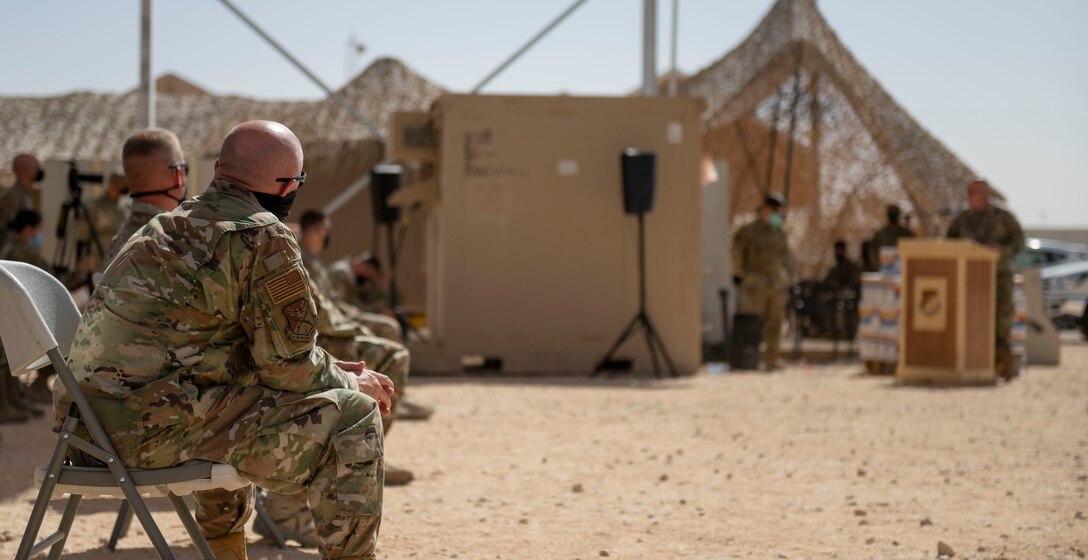 Members of the 378th Air Expeditionary Wing listen to remarks by U.S. Air Force Chief Master Sgt. Matthew Norvell, assigned to the 378th Expeditionary Operations Group, during a Remembrance Ceremony Sept. 11, 2021, at Prince Sultan Air Base, Kingdom of Saudi Arabia.