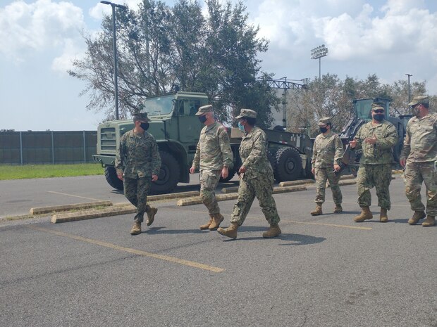 Brig. Gen. Kelliher, Officer in Charge of JFLCC Forward Command Element, and Brig. Gen Prendergast, commander of Task Force 51, discuss current operations with LT Jasmine Aldino and Senior Chief Construction (SCW/EXW) Jason Fletcher around the equipment staging area for DSCA operations in response to Hurricane Ida relief efforts. (Released/U.S. Marine Corps photo by 1st Lt. Aaron Ladd)