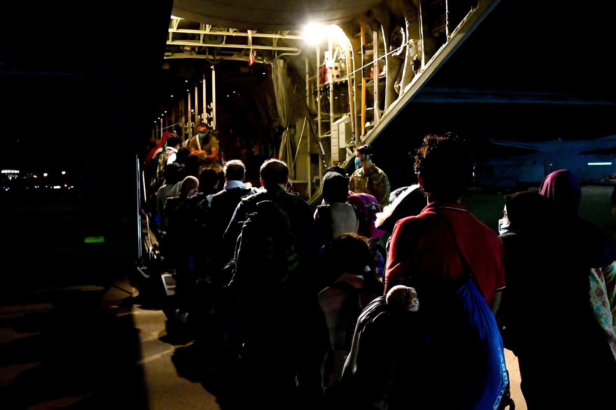 Afghan evacuees board a C-130J