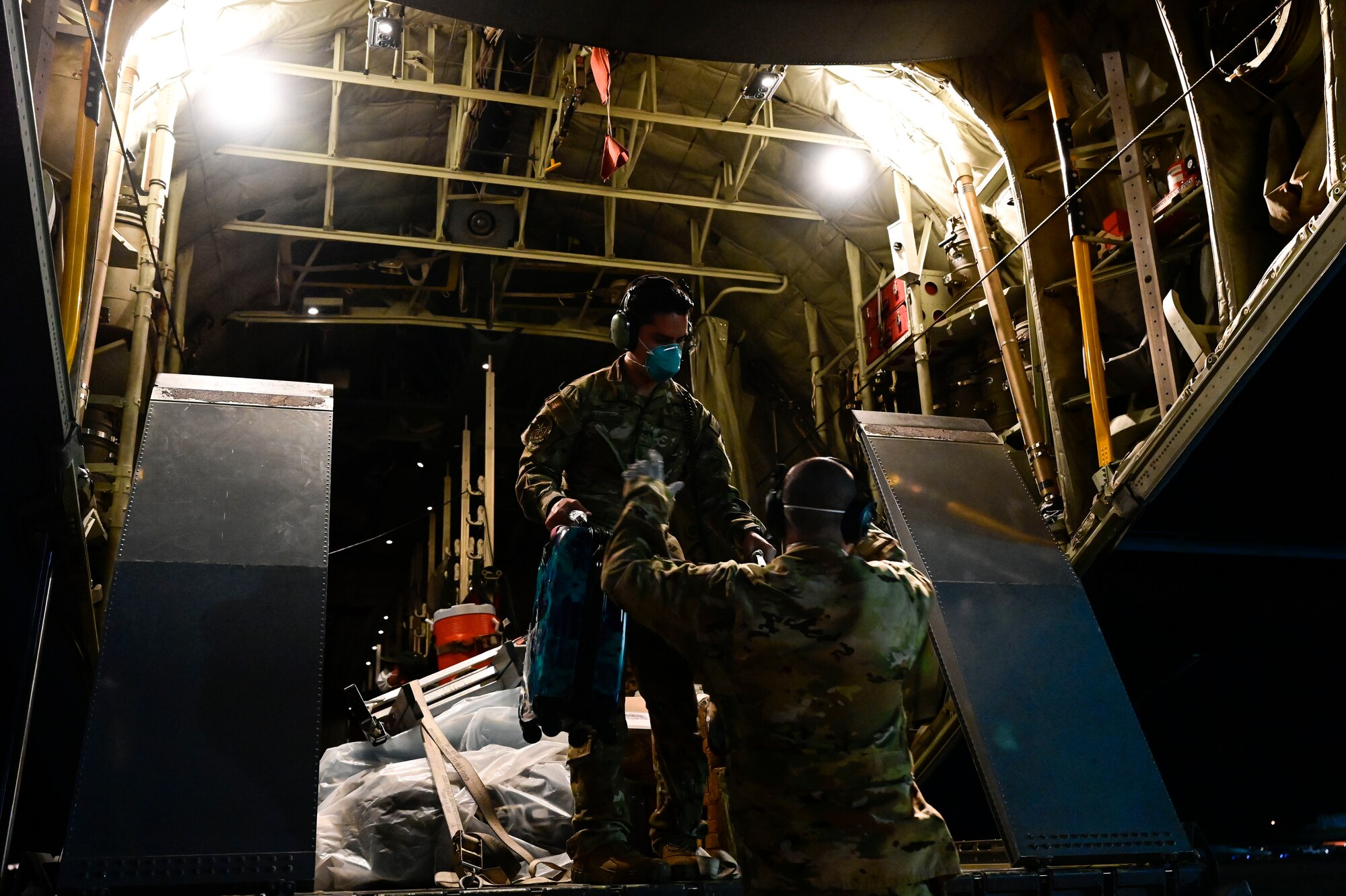 Airmen load cargo onto a C-130J