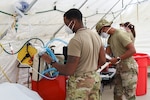 The 159th Medical Group Chemical, Biological, Radiological/Nuclear, and Explosive (CBRNE) Enhanced Response Force Package sets up mobile medical stations at the Terrebonne General Health System in Houma to augment a badly damaged hospital in the aftermath of Hurricane Ida on Sept. 6, 2021.