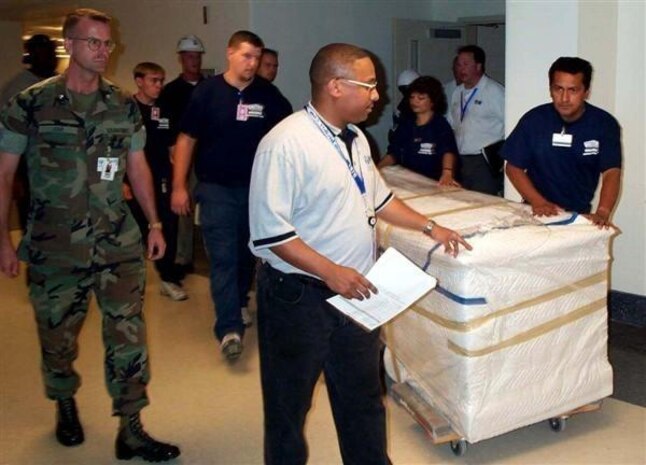 Then-Lt. Col. Darren Jump, left, counsel for environmental and land use with the Office of Counsel for the Commandant, walks alongside a desk being moved into an office in the E Ring at the Pentagon in Arlington, Virginia, in an undated photo from 2002. Jump was one of the first Marines who returned to offices in the E Ring after that part of the Pentagon was renovated following the attacks on 9/11.