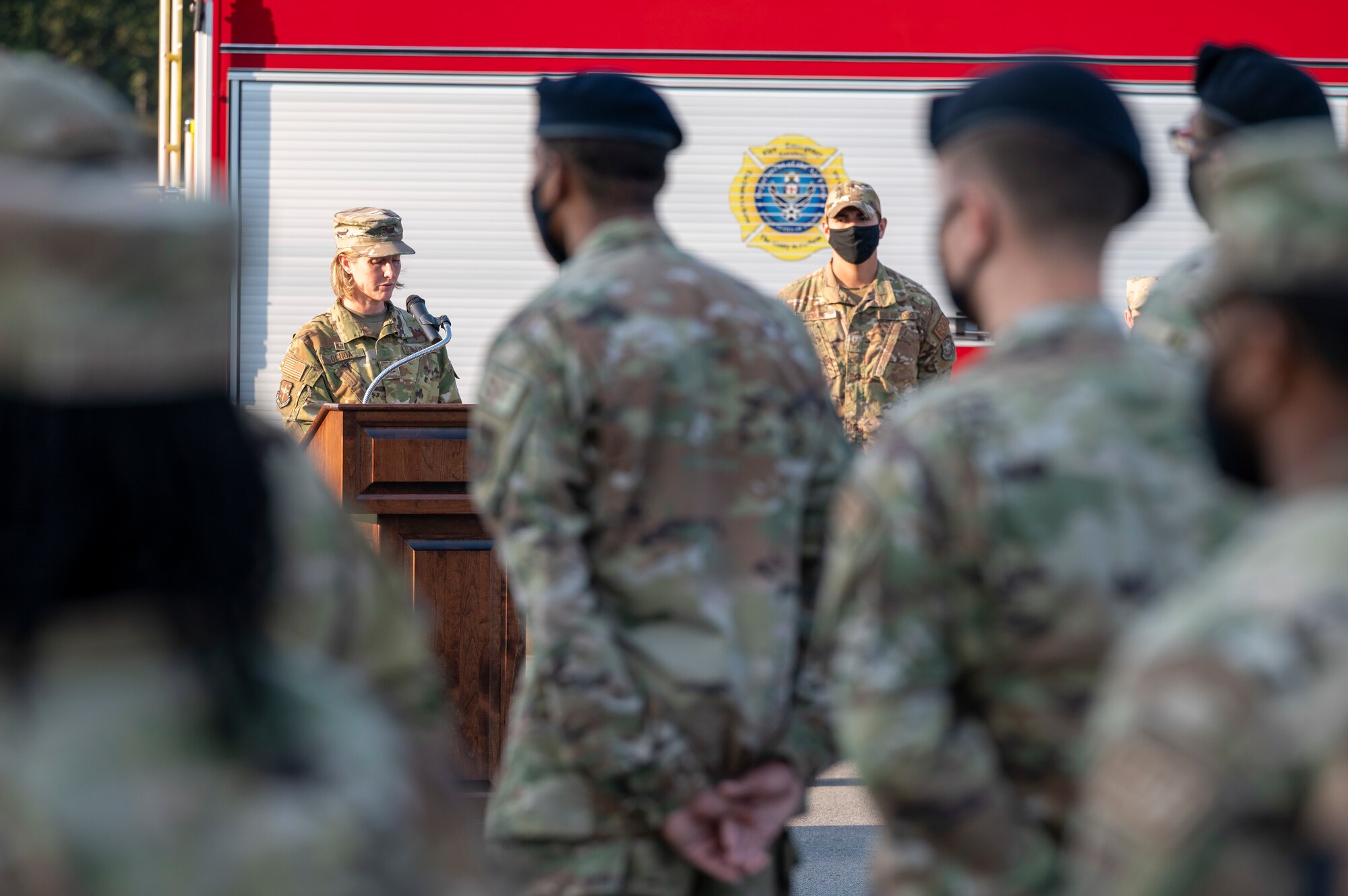 An Airman gives remarks during a ceremony
