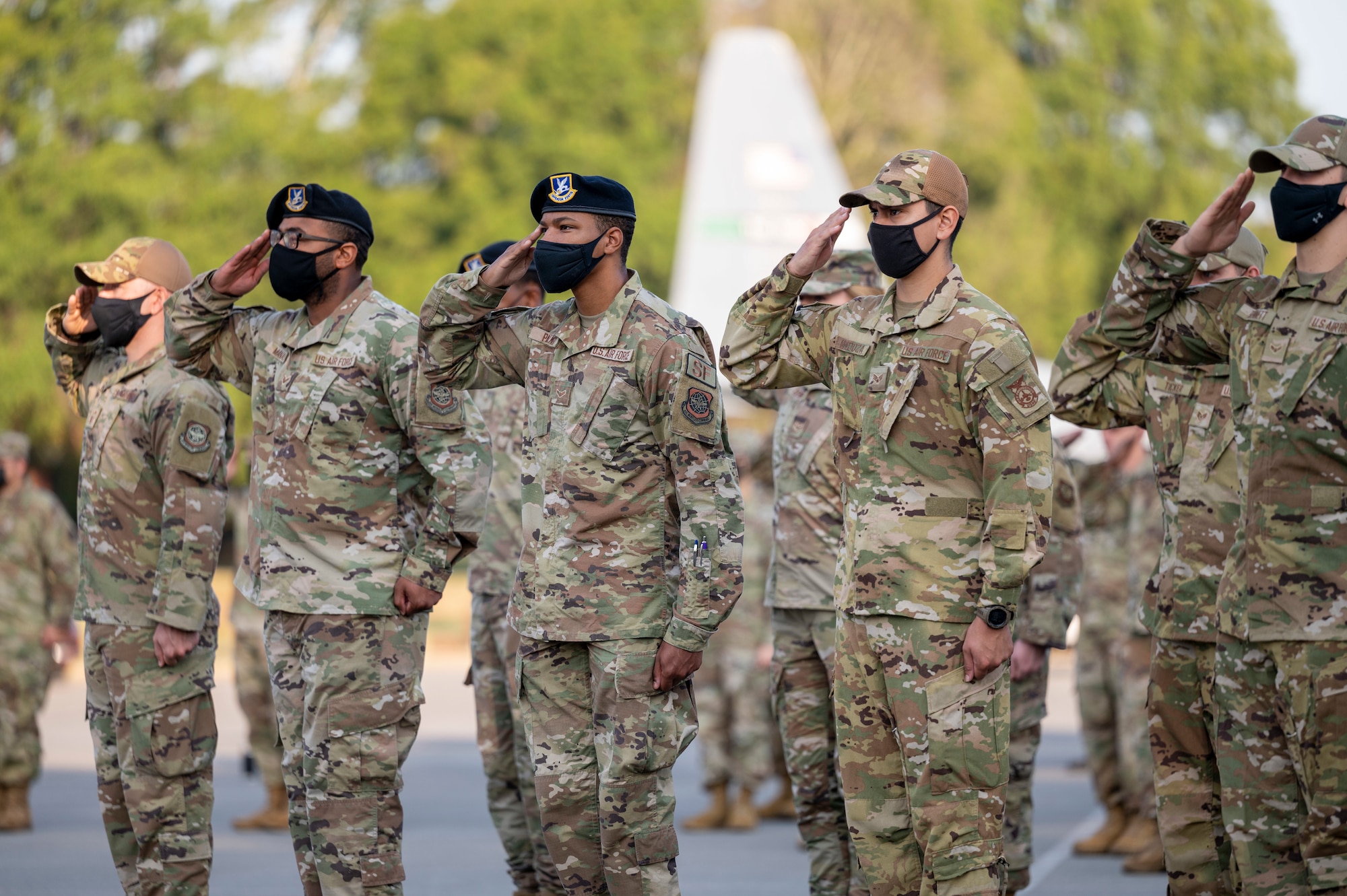 Airmen render a salute while in formation