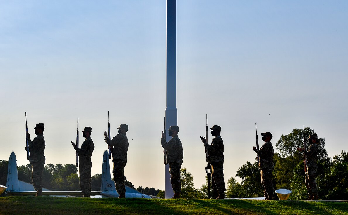 Airmen perform a 21-gun salute