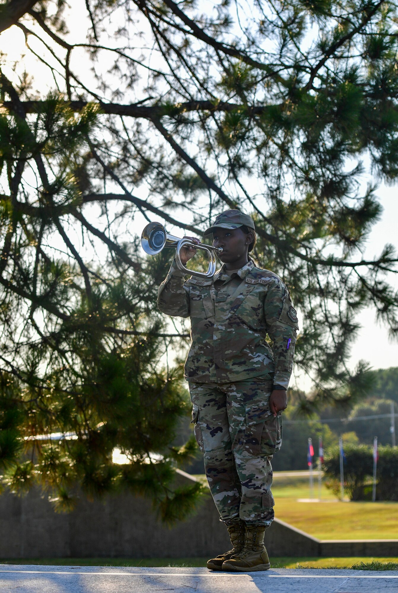 An Airman plays Taps on a bugle