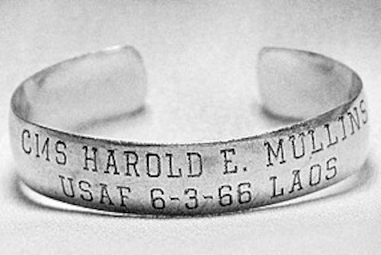 A bracelet is engraved with the name of Air Force Chief Master Sgt. Harold Mullins, the date he went missing and the location.