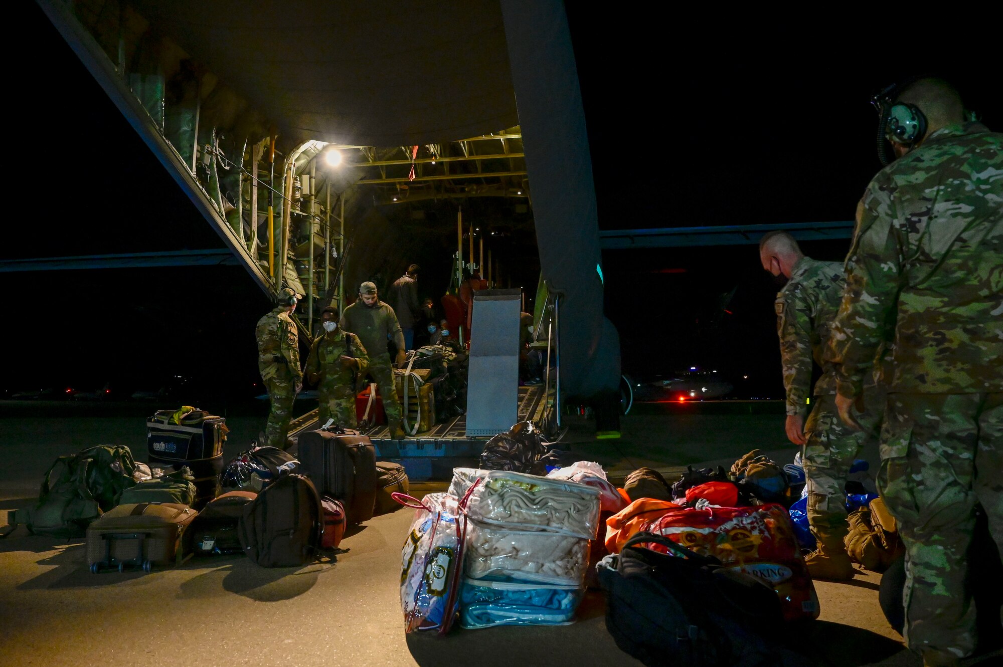 Airmen load cargo onto a C-130J