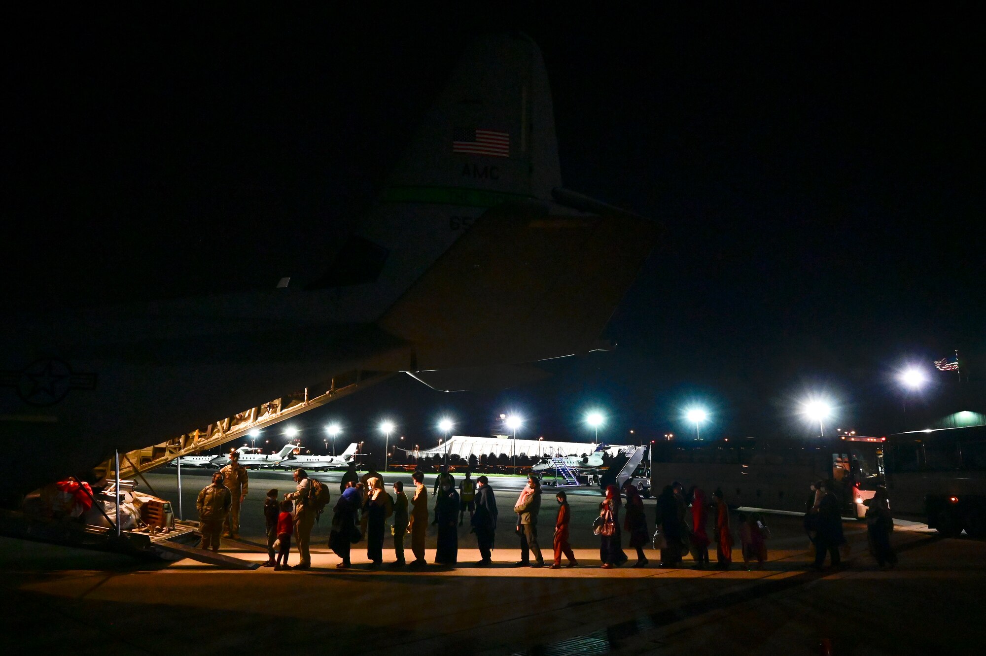Afghan evacuees board a C-130J