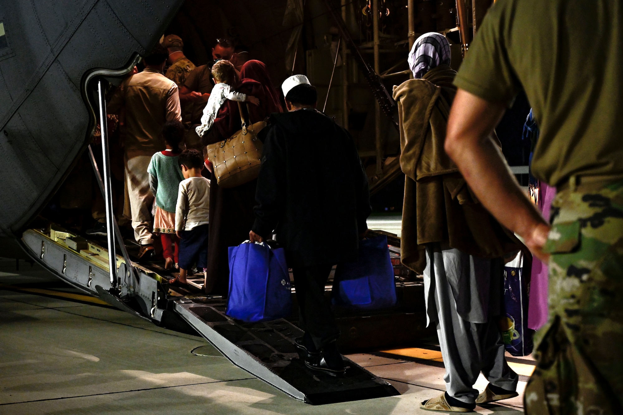 Afghan evacuees board a C-130J