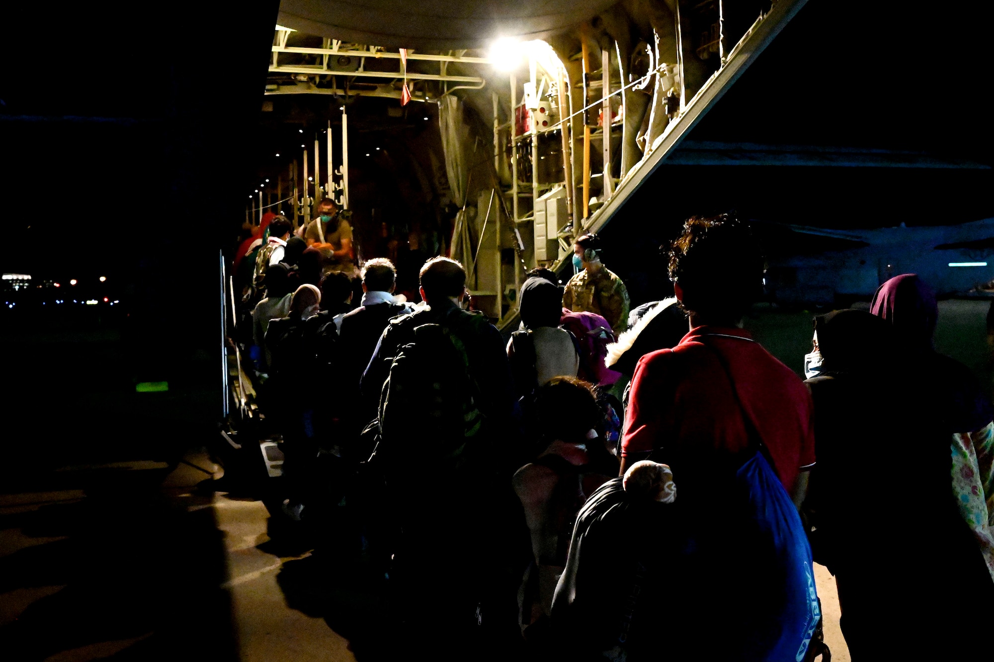 Afghan evacuees board a C-130J