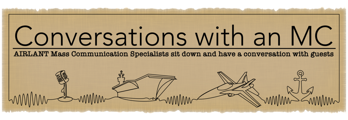 Banner depicting a microphone, aircraft carrier, jet and anchor