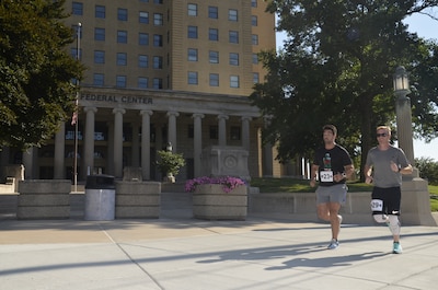 two men running in front of a building