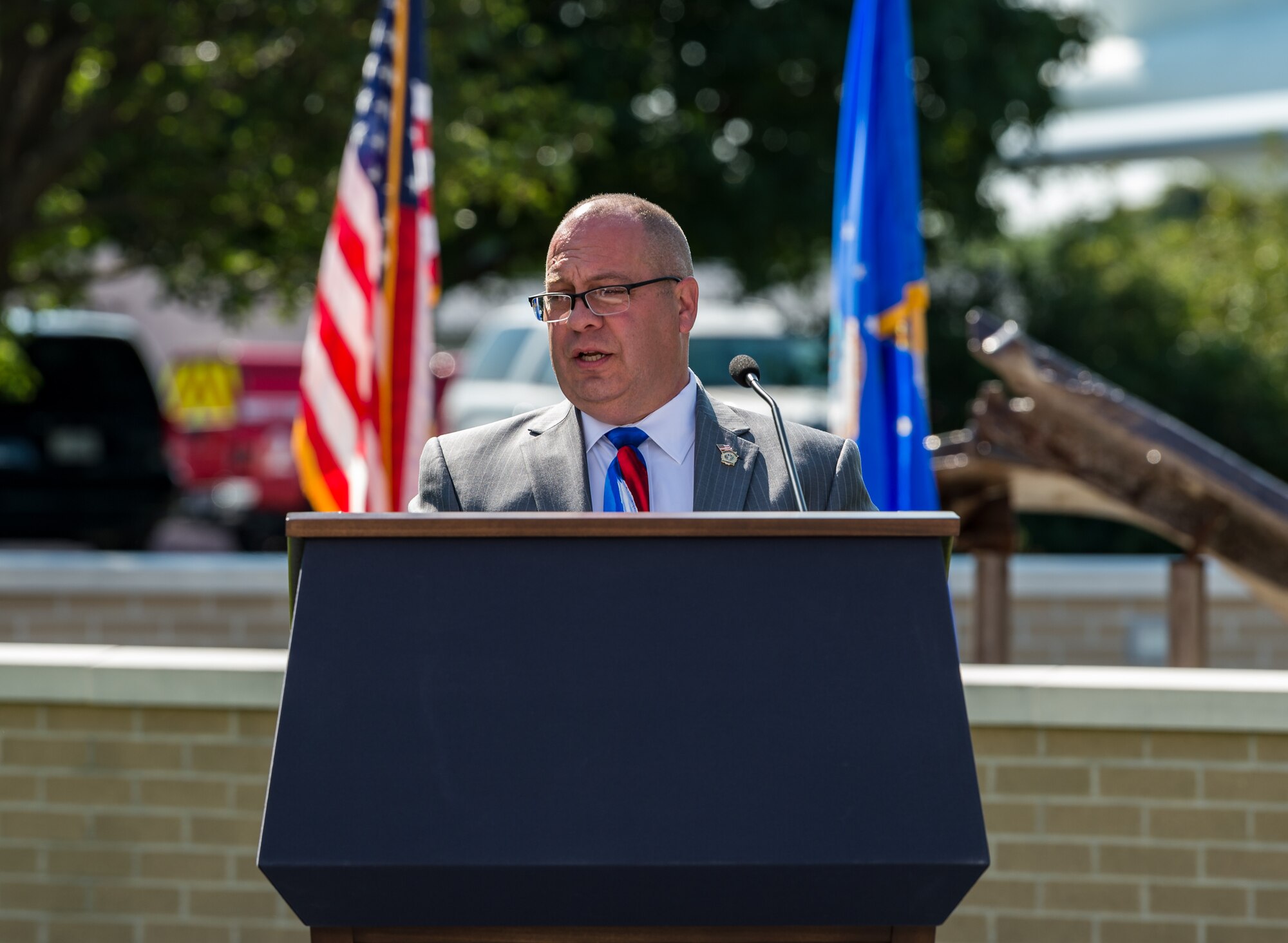 Retired Air Force Reserve Master Sgt. Tyree Bacon addresses attendees during the 20th Anniversary 9/11 Remembrance Ceremony held at the Air Mobility Command Museum’s 9/11 Memorial on Dover Air Force Base, Delaware, Sept. 11, 2021. Bacon was one of 20 New York State court officers who responded to the terrorist attacks on the World Trade Center in New York Sept. 11, 2001. (U.S. Air Force photo by Roland Balik)