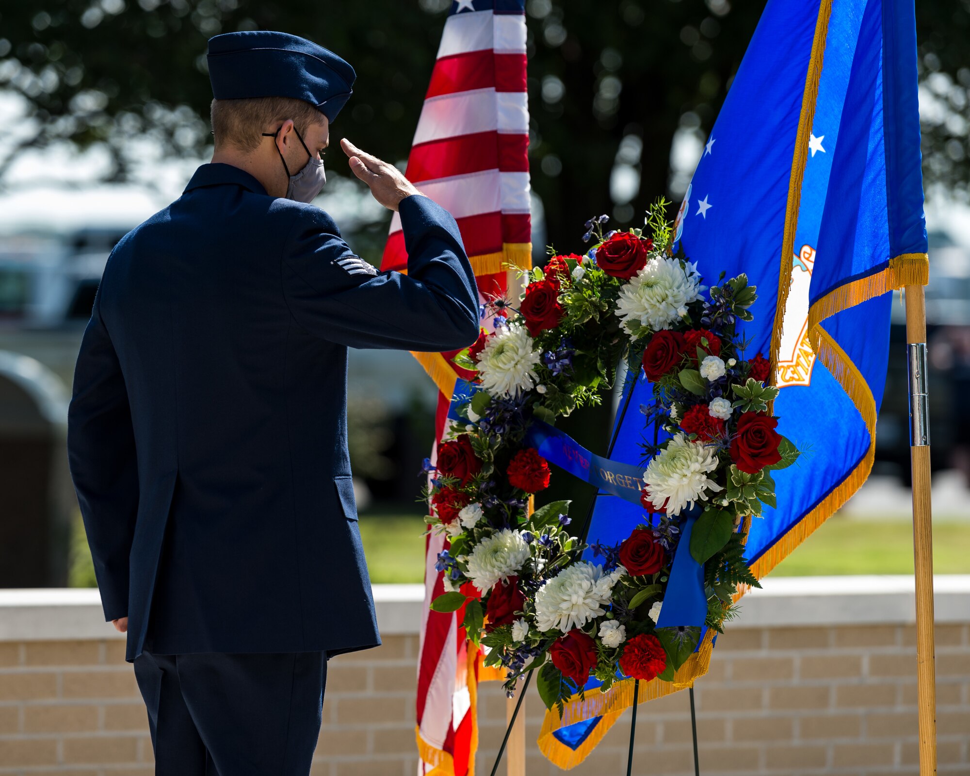 Senior Airman Kyle Spence, 436th Civil Engineer Squadron fire department operator, renders a salute during the 20th Anniversary 9/11  Remembrance Ceremony held at the Air Mobility Command Museum’s 9/11 Memorial on Dover Air Force Base, Delaware, Sept. 11, 2021. Spence placed the wreath at the memorial in remembrance for all those who died in the terrorist attacks on the World Trade Center in New York Sept. 11, 2001. (U.S. Air Force photo by Roland Balik)