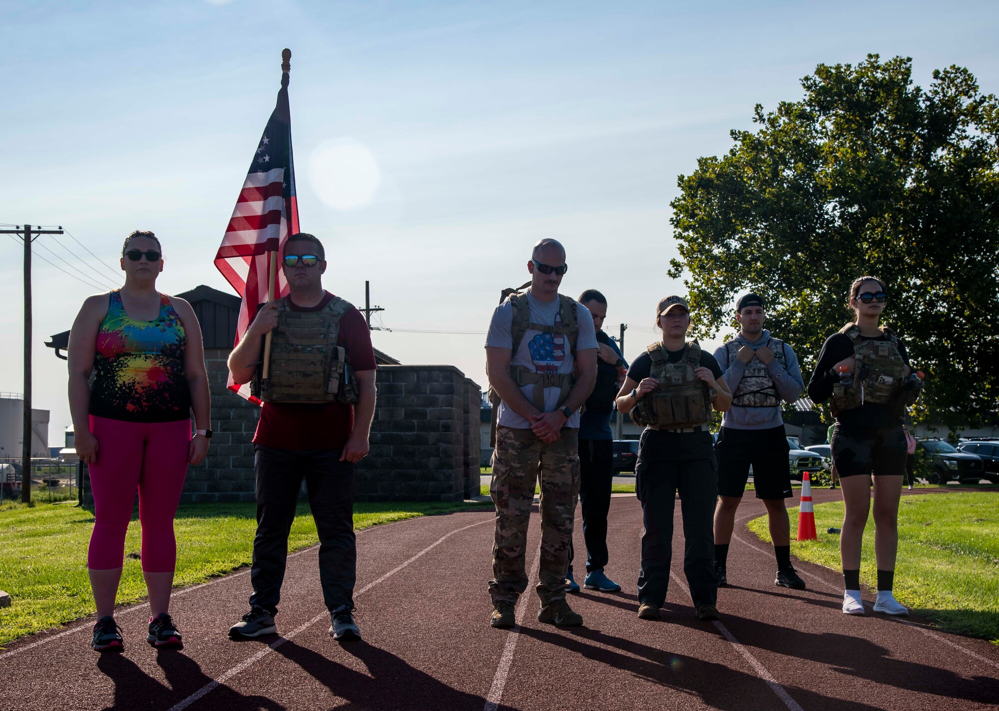 Team Dover members pause at 9:03 a.m. to signify the second World Trade Center Tower being struck during the 9/11 Remembrance Ruck March on Dover Air Force Base, Delaware, Sept. 11, 2021. Units from Team Dover rucked in 30-minute increments for more than 25 hours, remembering and honoring those who perished in the attacks on Sept. 11, 2001. (U.S. Air Force photo by Senior Airman Stephani Barge)