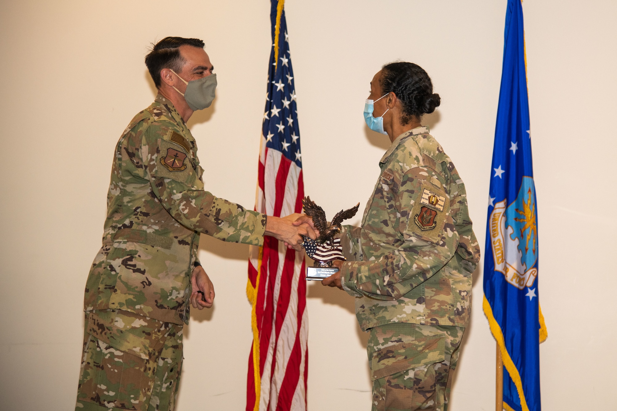 Col. Stuart M. Rubio, 403rd Wing commander, shakes Lt. Col. Marla Stewart's hand after presenting her with the Field Grade Officer of the Quarter award during a commander's call at Keesler Air Force Base, Miss. Sept. 12, 2021. Stewart was recognized for her work within the 403rd Aeromedical Staging Squadron during the months of January through March this year.  (U.S. Air Force photo by Staff Sgt. Kristen Pittman)