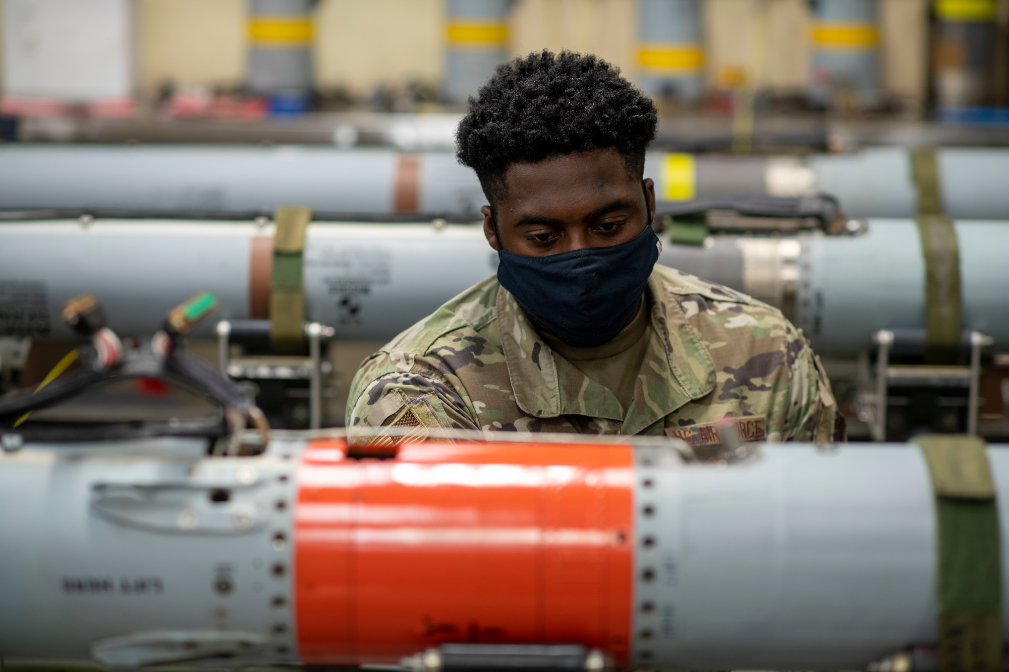 A man is sitting behind a missile