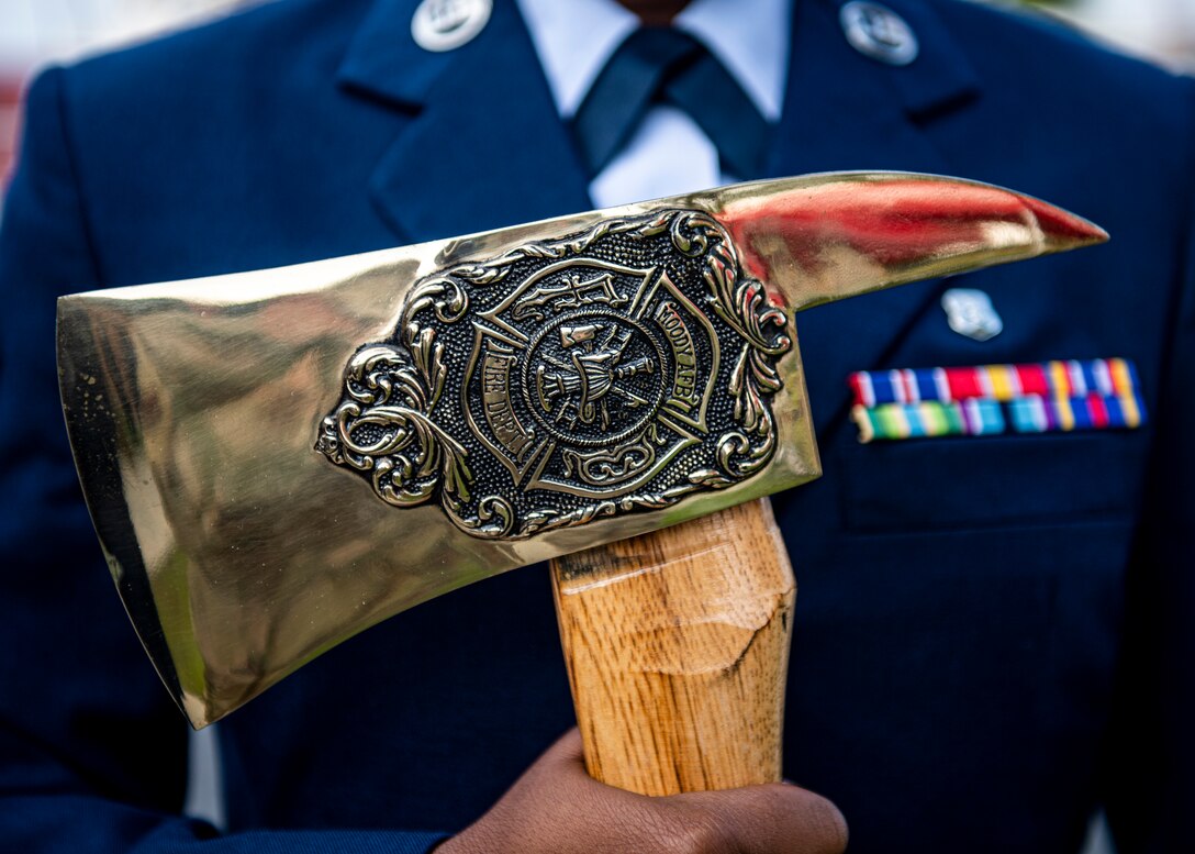 An Airman holds a ceremonial axe